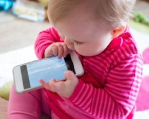 Child trying to chew a mobile phone