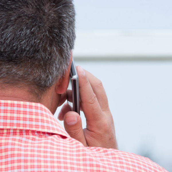 man holding mobile phone to his ear