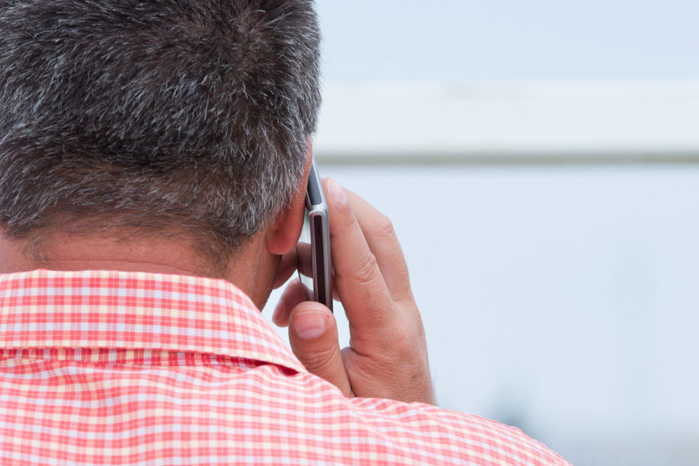 man holding mobile phone to his ear